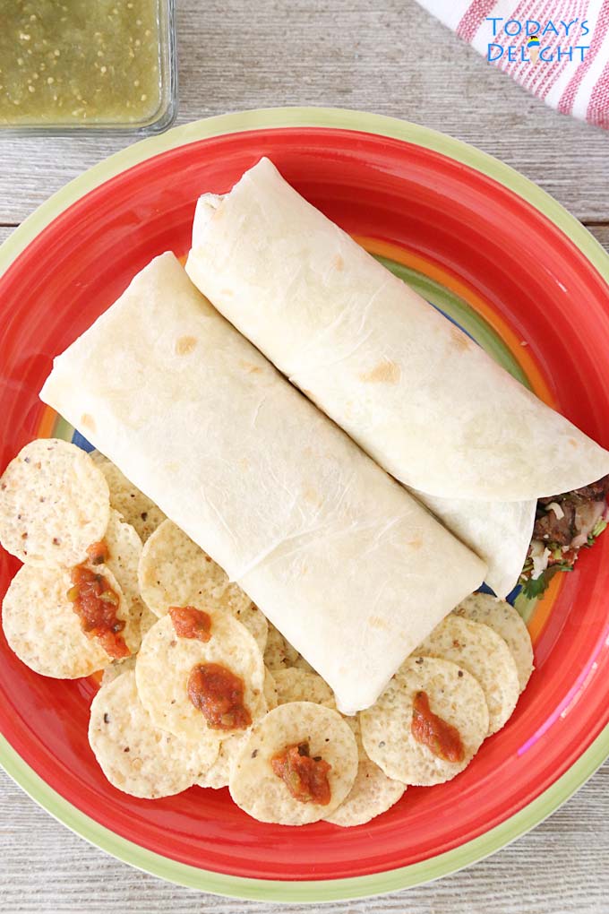 2 Mexican burritos with chips and salsa.