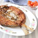 Fried marinated fish, white rice and cherry tomatoes.