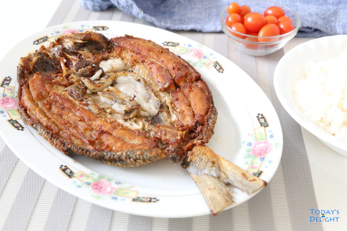 Fried marinated fish, white rice and cherry tomatoes.