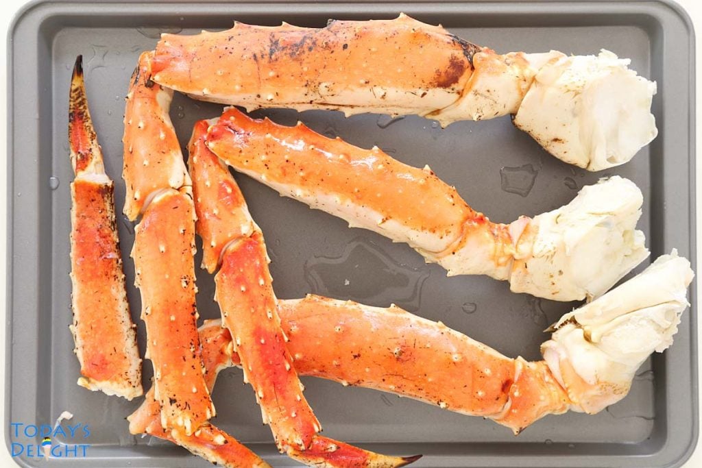 3 thawed King crab legs on tray.