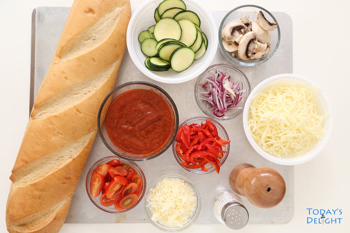 Ingredients to make Veggie French Bread Pizza - French Bread, pizza sauce, cheese, vegetables and seasonings.