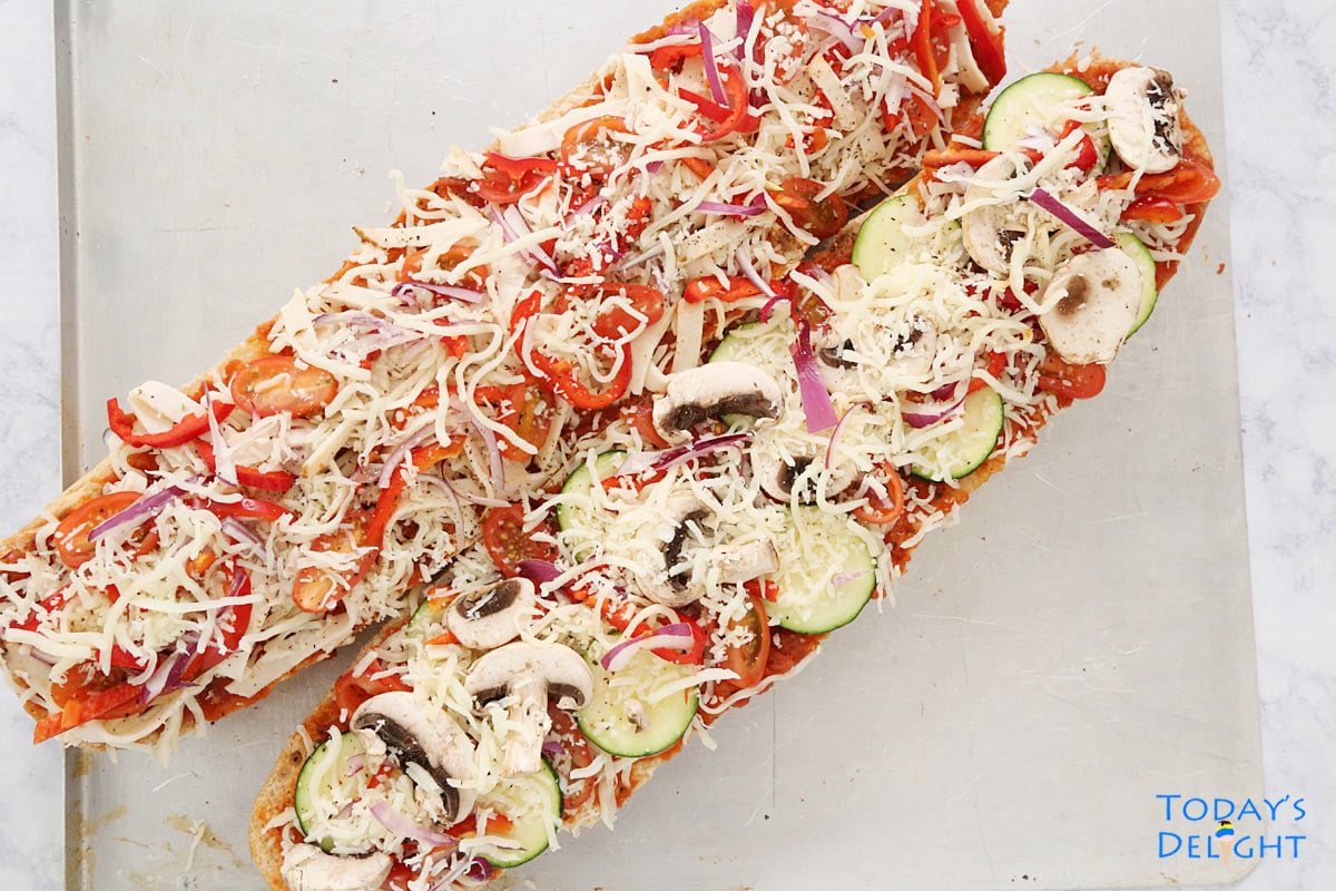 French bread sliced lengthwise and made into 2 Veggie French Bread Pizza.
