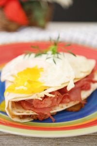 Monte Cristo Sandwich in tortilla wrap with broken over easy egg yolk.