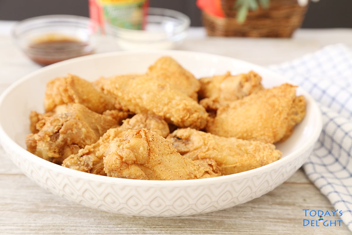 Crispy Patis Fried Chicken Wings in serving plate with ketchup, blue cheese dressing and sweet and spicy sauce.