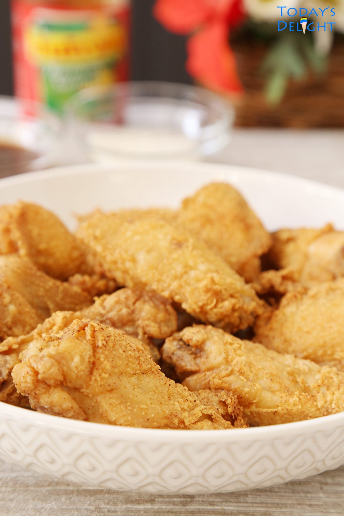 Crispy chicken wings in serving plate with ketchup, sweet and spicy sauce and blue cheese sauce on the side. 