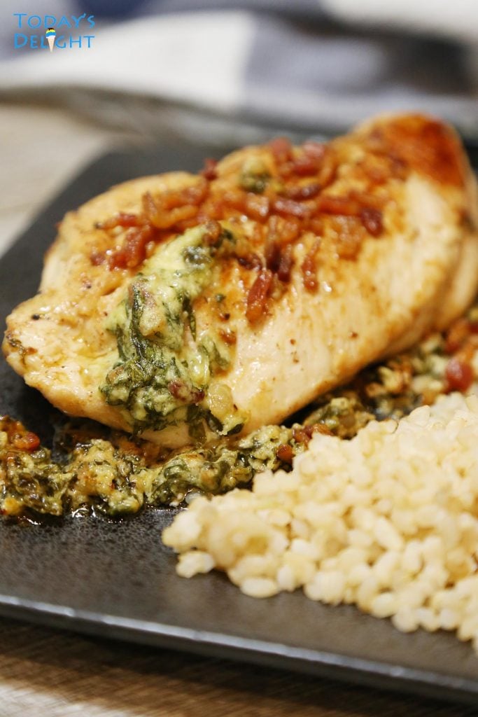 Cheesy stuffed chicken garnish with bacon and side or brown rice.