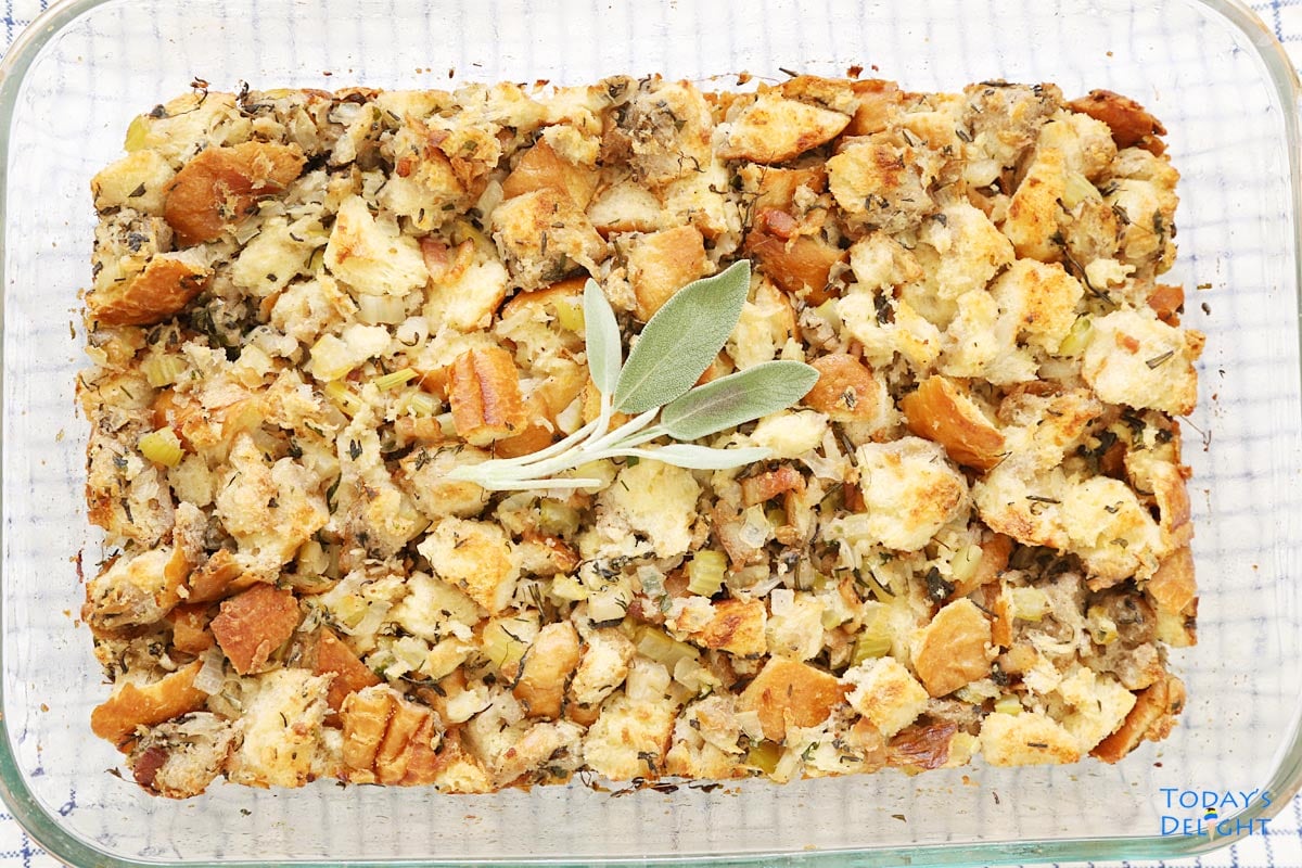 Turkey dressing with sage leaves garnish in a 9x13 casserole pan.