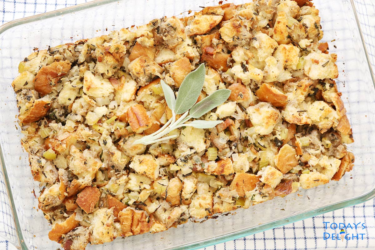 A 9x13 pan of turkey stuffing with sage leaves garnish.