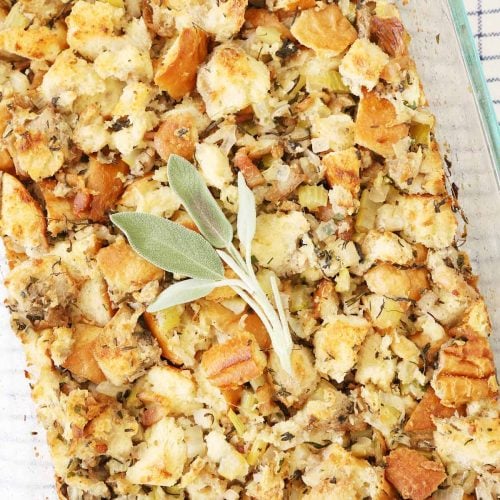 Turkey stuffing in a 9x13 pan garnish with sage leaves.