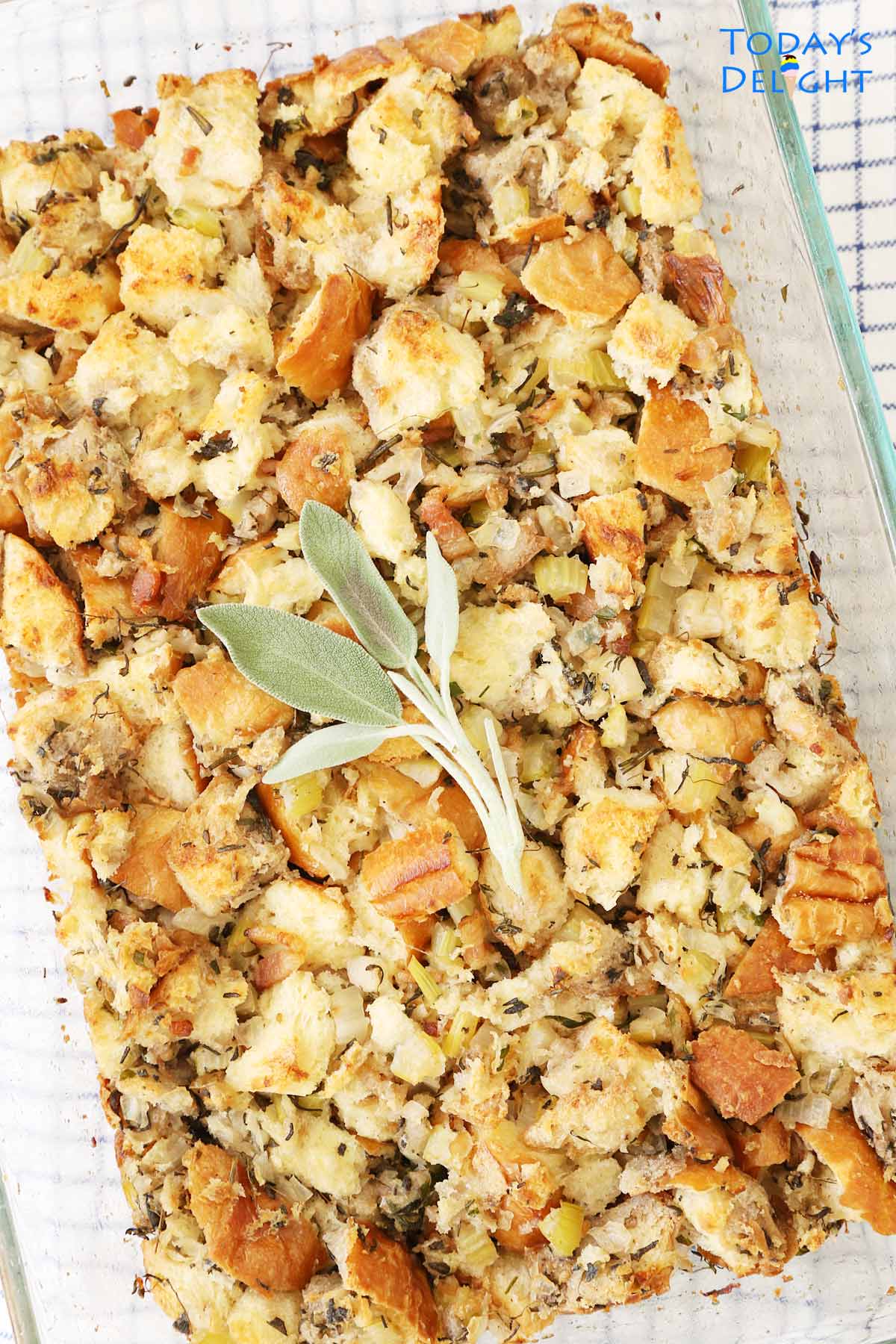 Turkey stuffing in a 9x13 pan garnish with sage leaves.