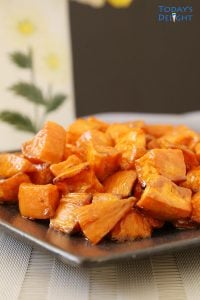 A plate full of roasted sweet potatoes.