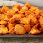 Oven roasted sweet potatoes on a gray square plate.