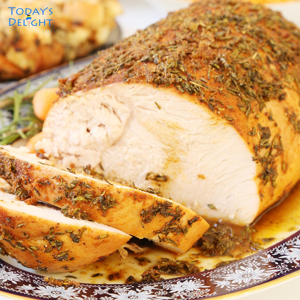 Sliced roasted boneless skinless turkey breast in a serving platter with drippings and sides.