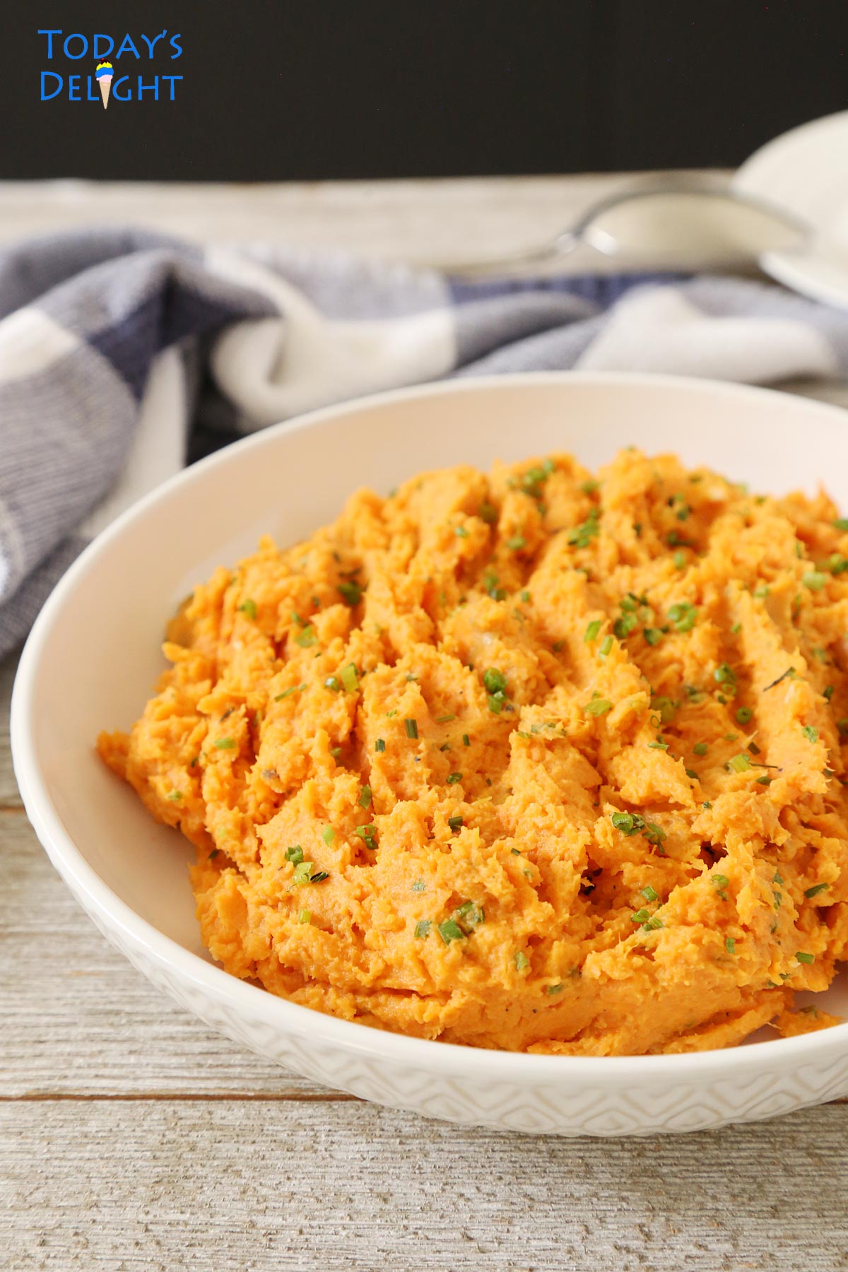 Mashed sweet potatoes side dish in a shallow bowl.