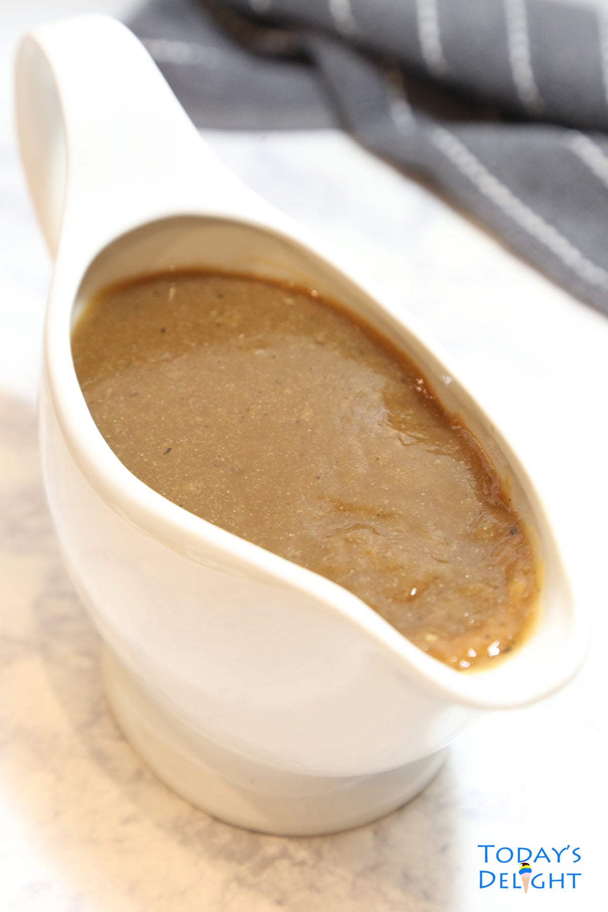 Brown gravy in a sauce dish.