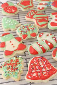 Different shaped decorated Christmas sugar cookies on a rack