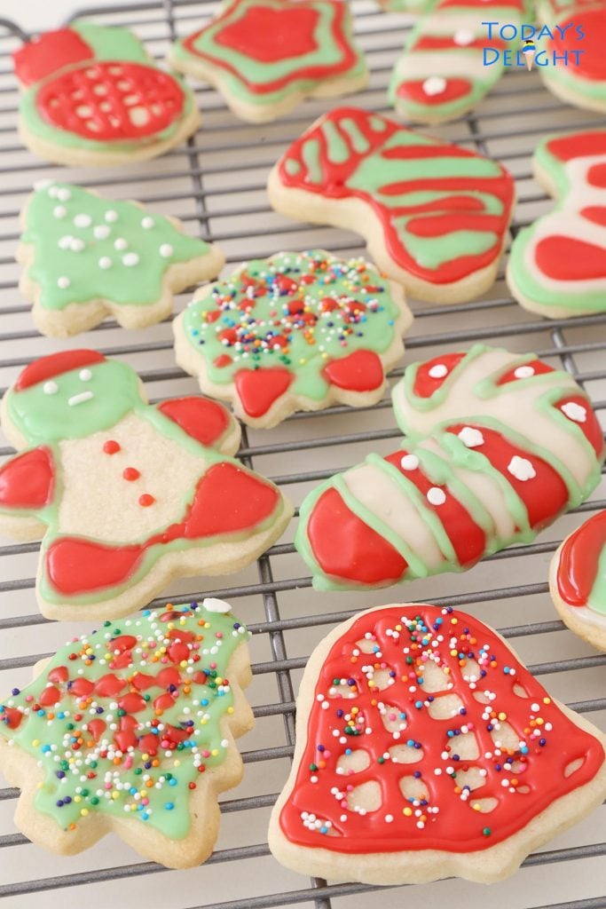 Different shaped decorated Christmas sugar cookies on a rack
