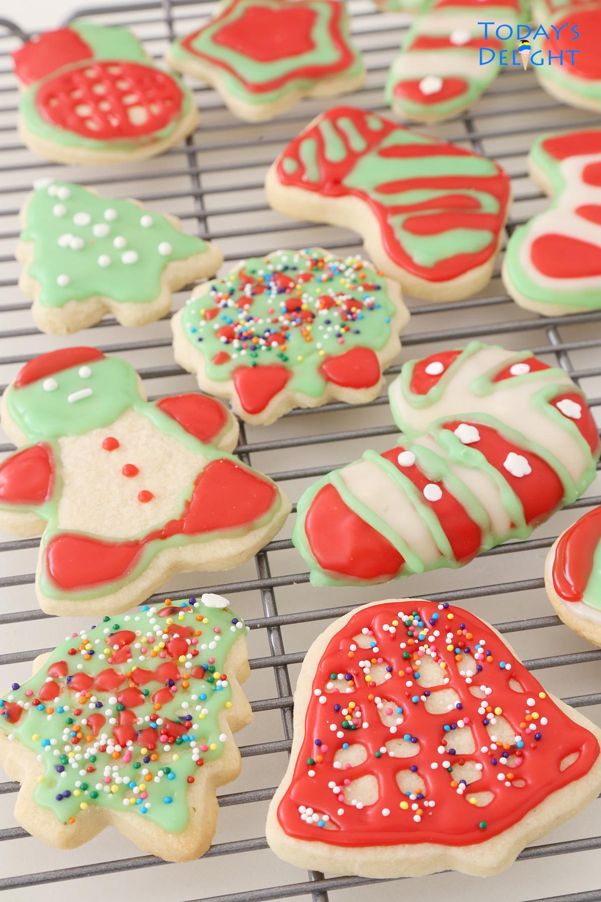Different shaped decorated Christmas sugar cookies on a rack