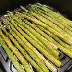 Cooking asparagus in air fryer for 7 minutes.
