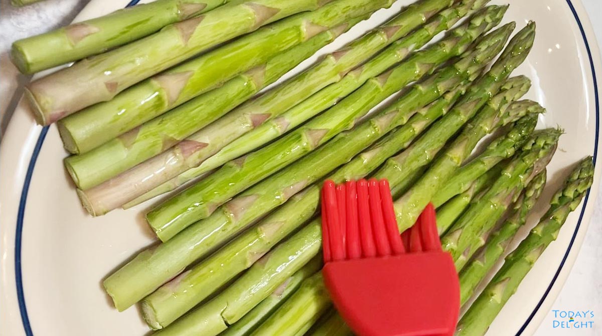 Brush asparagus with oil.