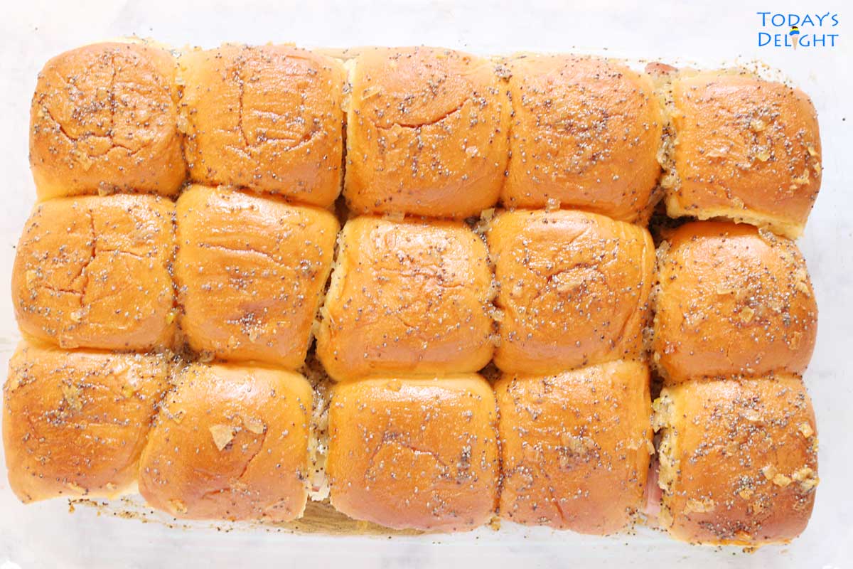 Fifteen baked sliders in baking pan.
