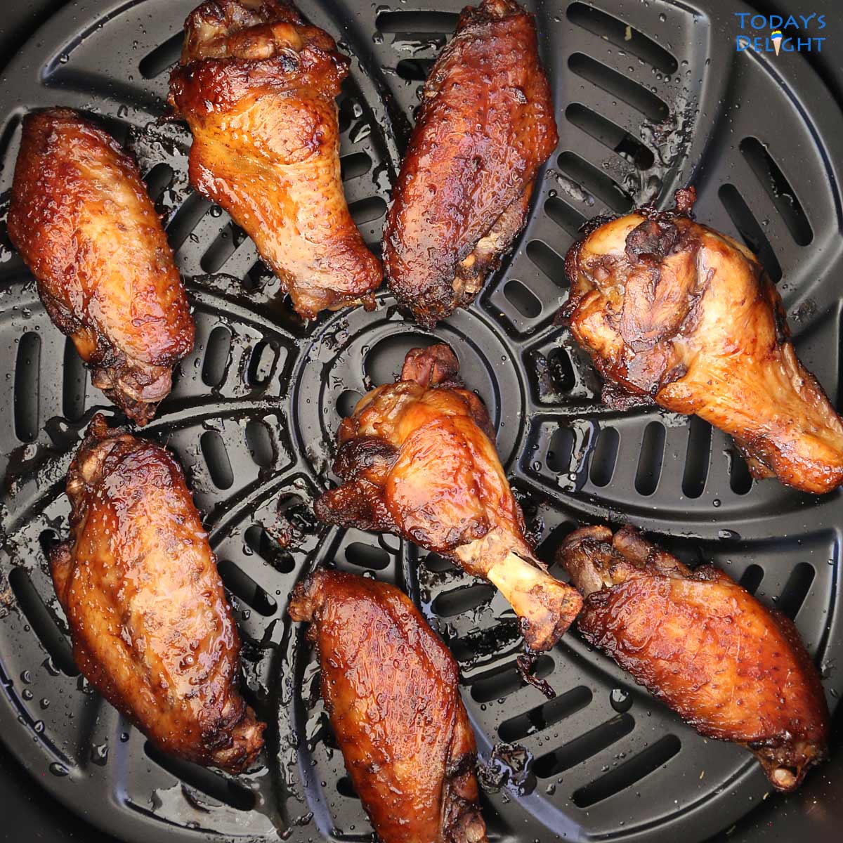 8 pieces of air fried chicken wings in basket.