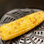 One air fried corn on the cob in basket.