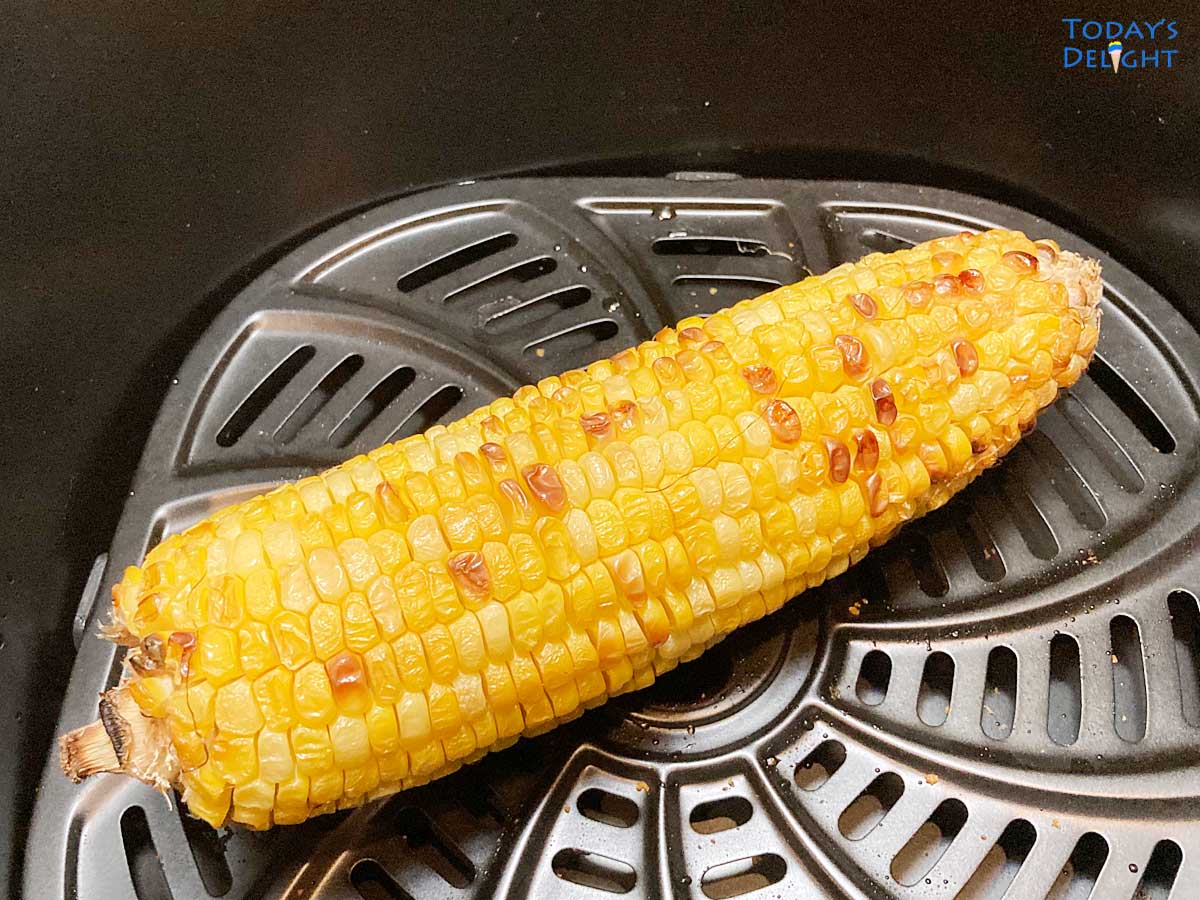 One air fried corn on the cob in basket.