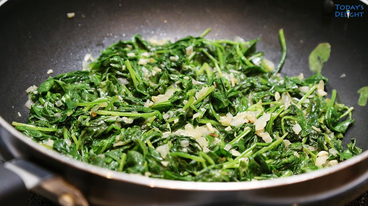 Sauteing spinach in a big skillet.